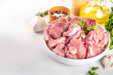 Veal, beef red meat raw chopped goulash, with herbs, condiment, olive oil and spices, cooking dinner background copy space