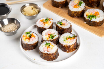 Gimbap or kimbap, korean rolls, traditional dish. Homemade kimbap roll with ham, vegetables and lettuce