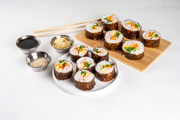 Gimbap or kimbap, korean rolls, traditional dish. Homemade kimbap roll with ham, vegetables and lettuce