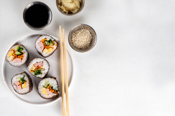 Gimbap or kimbap, korean rolls, traditional dish. Homemade kimbap roll with ham, vegetables and lettuce