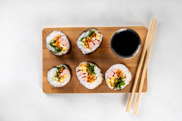 Gimbap or kimbap, korean rolls, traditional dish. Homemade kimbap roll with ham, vegetables and lettuce