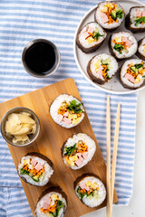 Gimbap or kimbap, korean rolls, traditional dish. Homemade kimbap roll with ham, vegetables and lettuce