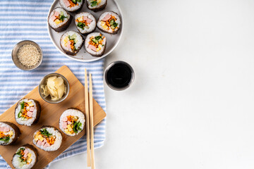 Gimbap or kimbap, korean rolls, traditional dish. Homemade kimbap roll with ham, vegetables and lettuce