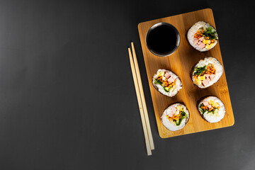 Gimbap or kimbap, korean rolls, traditional dish. Homemade kimbap roll with ham, vegetables and lettuce