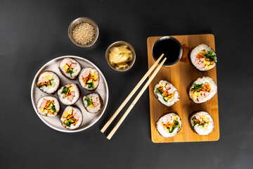 Gimbap or kimbap, korean rolls, traditional dish. Homemade kimbap roll with ham, vegetables and lettuce