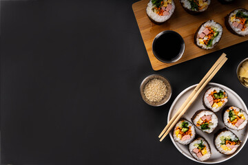 Gimbap or kimbap, korean rolls, traditional dish. Homemade kimbap roll with ham, vegetables and lettuce