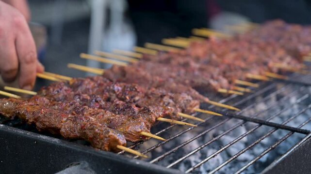 grilling meat on wooden skewers