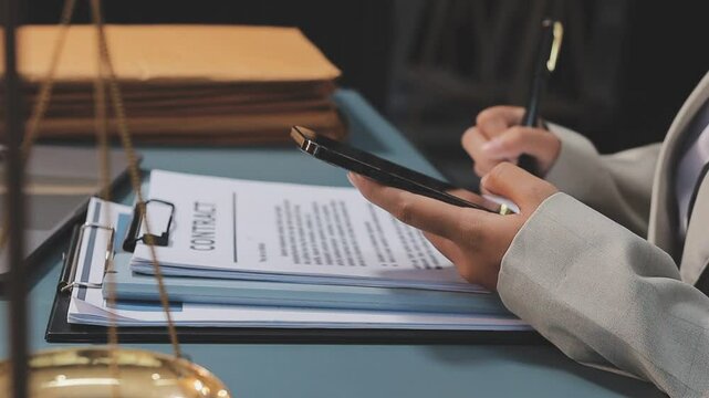 Professional Female Lawyer Working at Desk with Laptop and Legal Documents in Modern Office
