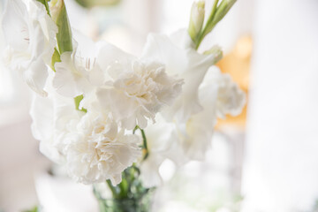Beautiful bouquet of white carnations and gladiol