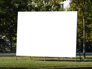 Blank billboard for advertisement template. Empty poster mockup on a mobile frame located in a city area. Copy space for testing a marketing campaign.