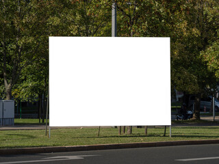 Advertisement mockup for big posters in a city next to a street. Copy space as template to test a marketing campaign. Blank billboard located at a road.