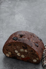 Sweet rye bread with hazelnuts and dried fruits on gray table