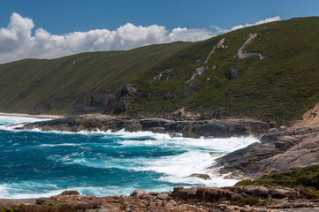 Rocky coastline at The Gap, Torndirrup National Park, near Albany, Western Australia. The image shows steep cliffs and rough ocean waters, typical of the rugged natural landscape of the area.
