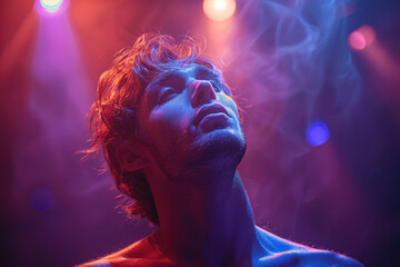 Young man enjoying nightclub atmosphere with colorful lights