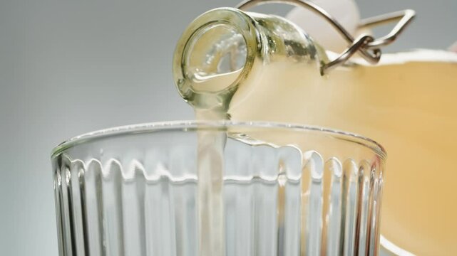 Apple cider, Orange or white wine bottle and glass, spanish french apple cider pouring, pouring of ecological natural wine. 