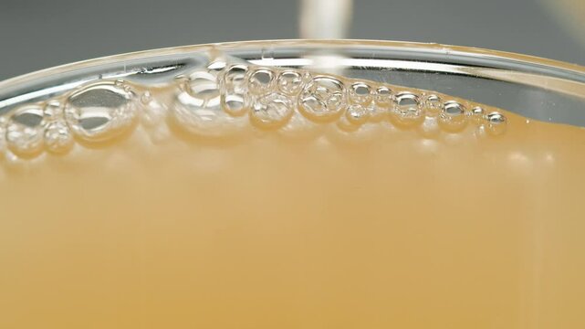 Apple cider, Orange or white wine bottle and glass, spanish french apple cider pouring, pouring of ecological natural wine. 