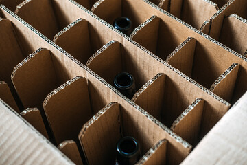 Corrugated cardboard beer bottle packaging with dividers. Sustainable packaging, beverage transport, beer shipping protection, eco-friendly material solutions.