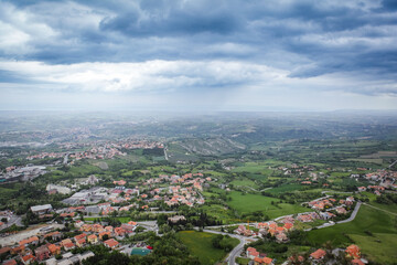 Naklejka premium Breathtaking view of the San Marino landscape under a cloudy sky during late afternoon