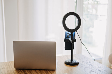 Home video recording setup with laptop and ring light, content creation, vlogging, remote work, online meetings, digital media production