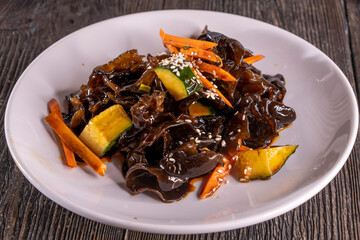 Wood Ear Mushroom Salad on wood table. Chinese food. wooden sticks, soy sauce. China Sichuan Food