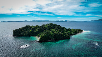 Aerial view of Nosy Tanikely island in Madagascar showcasing its vibrant greenery and clear waters during daylight hours