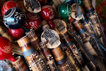 Explore the vibrant souvenirs of Madagascar featuring traditional instruments and handcrafted artifacts in a local market setting