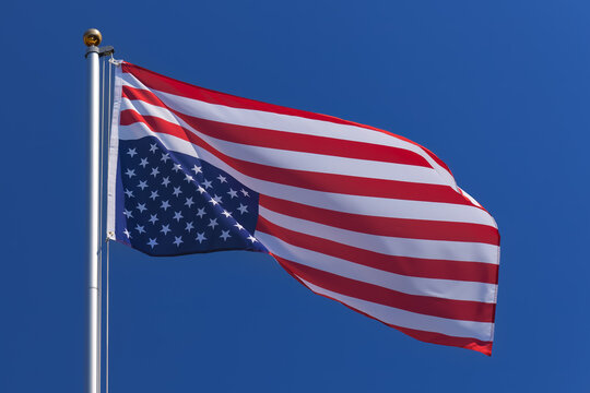 USA flag waving upside down on a flagpole