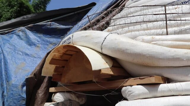 Close-up shot of an adobe house in the making under the blazing sun.