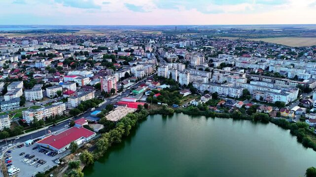 Aerial view of a small lake surrounded by buildings of flats in Navodari at sunset