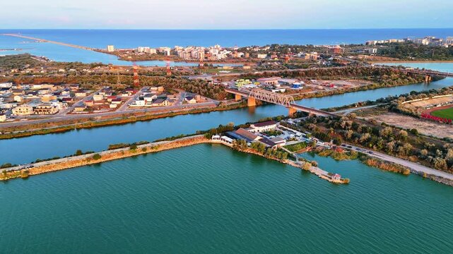 Aerial view of a bridge over the Tasaul lake at sunset