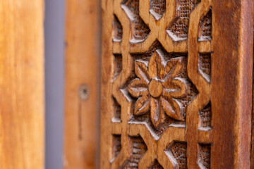 A wooden carving of a flower with a hole in the center