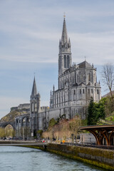 Fototapeta premium Lourdes Cathedral's Majestic Towers and Gothic Design