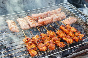 Grilled skewers chicken meat and fermented pork on barbecue grill