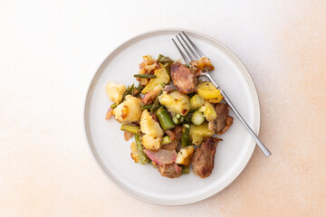 Stewed duck fillet with potatoes and asparagus and radishes, mixed salad of various greens, baked carrots in tahini sauce