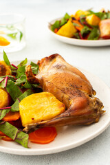 Enjoy a delicious, hearty meal with baked rabbit, roasted potatoes, and carrot salad, combining savory flavors and wholesome ingredients for a nutritious and satisfying dinner