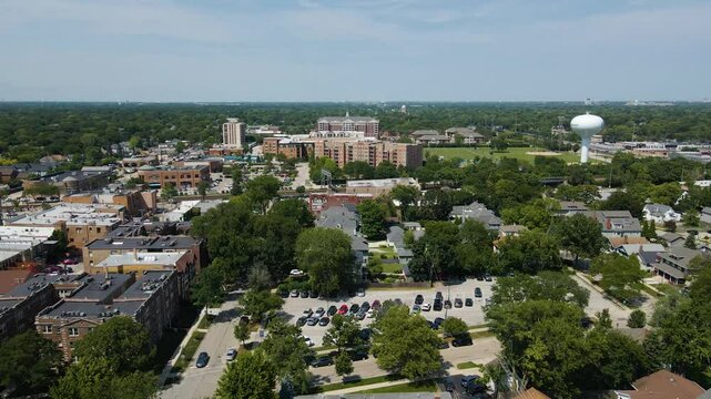 Wide aerial footage capturing La Grange, IL on a summer day, highlighting both residential neighborhoods and commercial downtown areas, with a clear view of the suburban landscape.