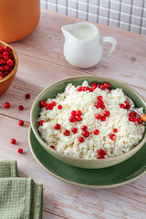 cottage cheese with berries in a bowl on the table