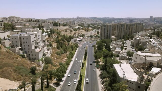 main road in northern Jerusalem. Drone shot
The city of Jerusalem can be seen to the entire horizon
Ramot Road or Golda Meir Road.
There are tall residential towers along the road.