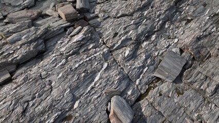 Looking down on rocks and stone formations found on rocky coastline of Maine