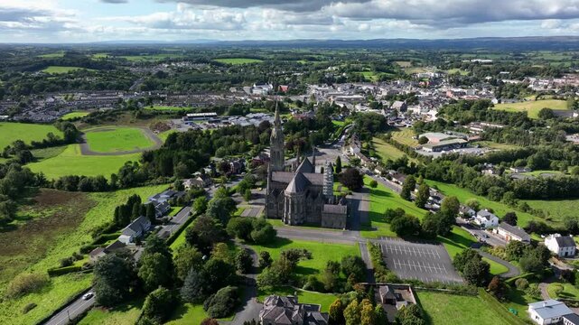 St. Macartan's Cathedral, County Monaghan, Ireland, September 2022. Drone orbits clockwise while slowly pushing closer showcasing the Gothic Revival church with Monaghan town in the distance.