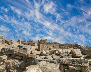 Ruins of Azraq Castle (Qasr al-Azraq) is a crusader castle (300AD),  central-eastern Jordan, 100 km east of Amman, Jordan. Against the background of a beautiful sky with clouds