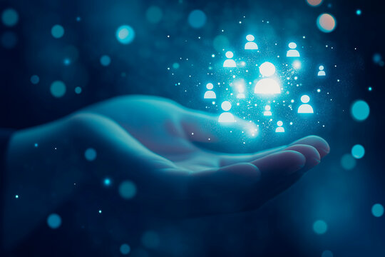 Hand presenting bright blue digital user icons representing social media, communication and technology.