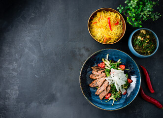 Asian lunch rice noodles with sweet pepper, homemade cheese with spinach, duck fillet salad.