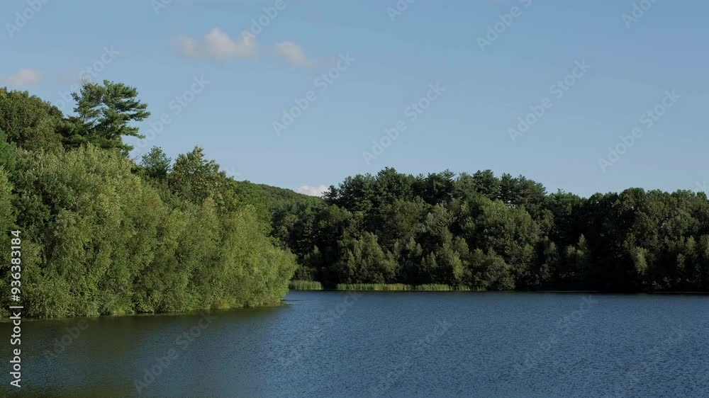 Canvas Prints Footage of a calm evening with still reflections and few clouds on the shore of East Mountain Reservoir, in Waterbury, Connecticut