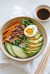 Elegant Korean bowl with avocado, cucumber, carrot slices, chicken, half-boiled egg, soy sauce, chopsticks, arranged simply on a beige dish with a white napkin.