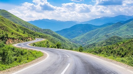 Naklejka premium Scenic highway with a car driving towards a majestic mountain range in the background.