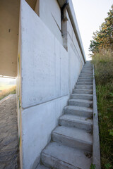 Reinforced Concrete road bridge over railway track during summer. Concrete suspension bridge surrounded by green meadows. 