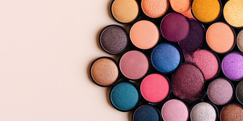 Vibrant eyeshadow palette showcase array rich pigmented colors isolated pale beige background