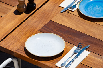 Before lunch time, empty stylish beach cafe with served tables waiting for guests in sunny Biarritz, France
