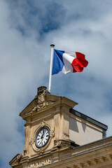 Blue red white french flag on roof of ciry hall in France